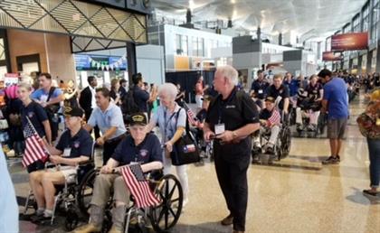 Passengers at Austin's airport greet Roy Jacoby WWI Vet with Jim Hawkins Caliber Sales Manager and Guardian along with other Vets on the Honor Flight 