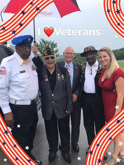 Photo of Erica Kelley with veteran attendees.