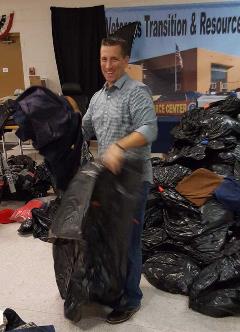Adam Costakes of Caliber Home Loans Learning Team sorting clothes for homeless Veterans