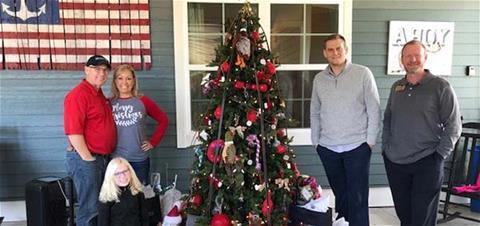 The picture, from l to r includes: Aaron Duez, his wife Tracie, their daughter Jolie, Chris Greaves, Production Assistant, and Paul Bednar with ReMax Realty pose with tree they decorated.